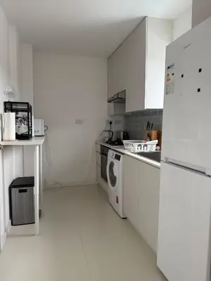 a white kitchen with a washer and dryer in it at Private Rooms Near Acton Main Line Direct Elizabeth Line to Heathrow in Moffat
