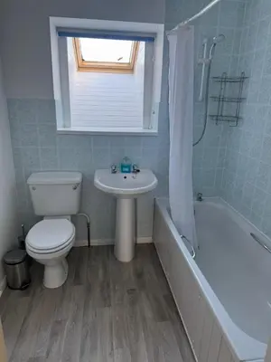 a bathroom with a toilet and a sink and a tub at Cozy cottage at the base of Sale and Ling Fell in Embleton