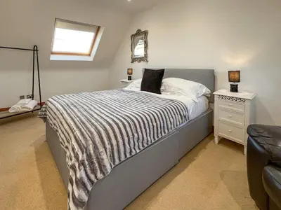 a bedroom with a bed and a mirror on the wall at Graeme-An-Taoiseach Uk50061 in Stranraer