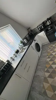 a kitchen with a washing machine and a window at Ella's Place in Moffat