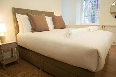 a large bed in a room with a window at River View Cottages in Annan