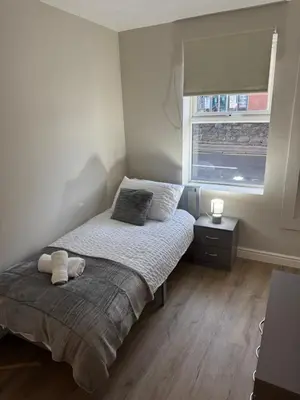 a small bedroom with a bed and a window at Work-Ready House Near Sellafield in Cleator Moor