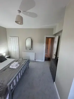 a bedroom with a large bed and a mirror at Work-Ready House Near Sellafield in Cleator Moor