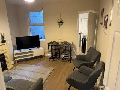 a living room with a tv and a table and chairs at Work-Ready House Near Sellafield in Cleator Moor
