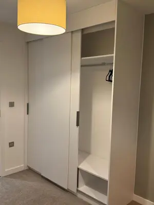 a closet with a white door and a lamp at Chalk in Moffat