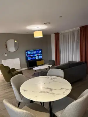 a living room with a couch and a table and chairs at Chalk in Moffat