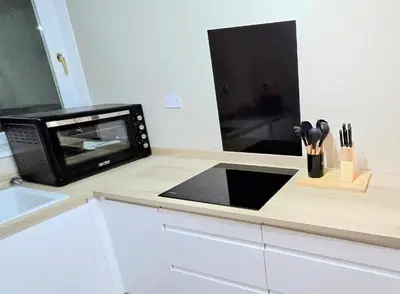 a microwave oven sitting on a counter in a kitchen at One Old Creamery in Sandhead