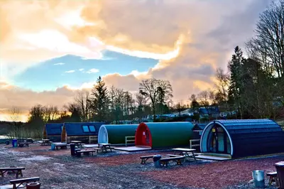 a group of tents and picnic tables in a field at Barrhill Holiday Park - Glamping in South West Scotland - Duisk in Girvan