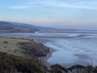an aerial view of a beach and the ocean at Cosy Cottage in Charming Village Close to Beach - Pass the Keys in Kirkbean