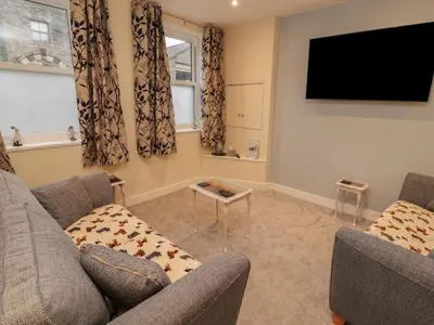 a living room with two couches and a flat screen tv at 20 Lorton Street in Cockermouth