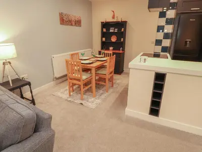 a living room with a table and chairs and a couch at 20 Lorton Street in Cockermouth