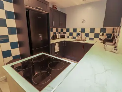 a kitchen with a stove in the middle of it at 20 Lorton Street in Cockermouth