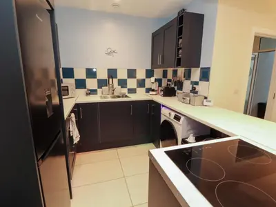 a kitchen with black cabinets and a black refrigerator at 20 Lorton Street in Cockermouth