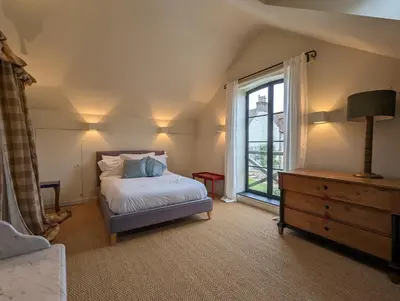 a bedroom with a bed and a window at The Granary in Moffat