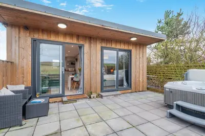 a house with a patio with a hot tub at 1 Bed in Gatehouse Of Fleet oc-t34445 in Gatehouse of Fleet