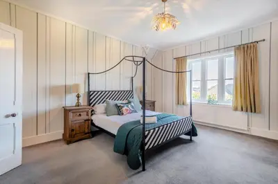 a bedroom with a canopy bed and a window at 4 Bed in Great Clifton oc-r34663 in Great Clifton