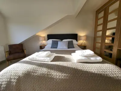 a bedroom with a large bed with two towels on it at Wetherlam View Little Langdale in Little Langdale