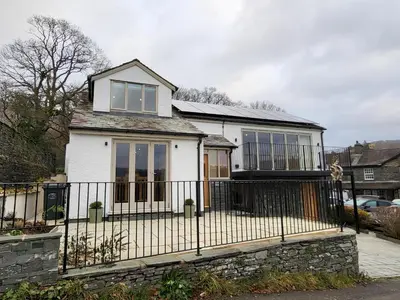 a white house with a wrought iron fence at Wetherlam View Little Langdale in Little Langdale