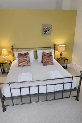a large bed in a room with two lamps at Portland Square in Carlisle