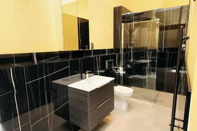 a bathroom with a sink and a toilet and a mirror at Portland Square in Carlisle