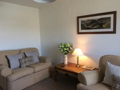 a living room with two couches and a coffee table at High Snab Cottage Newlands Valley in Keswick