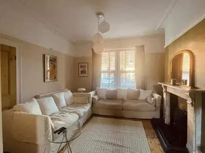 a living room with a white couch and a fireplace at The old townhouse in Carlisle