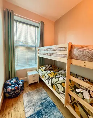 a bedroom with two bunk beds and a window at The old townhouse in Carlisle
