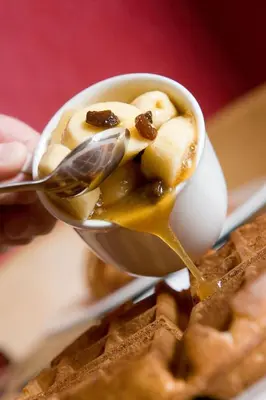 a spoon with peanut butter and bananas on top of waffles at Burnside B&B in Keswick