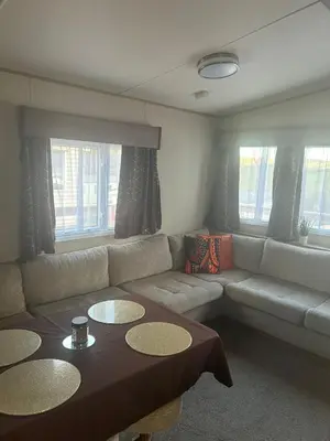 a living room with a couch and a table at BZ Green Haven Caravan in Ballantrae