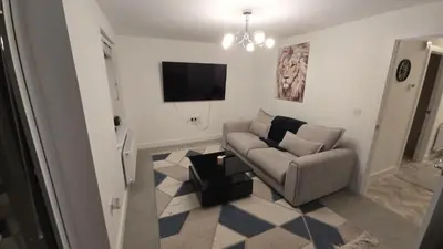a living room with a couch and a flat screen tv at 3,Lime Tree Ave in Moffat