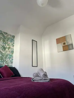 a bedroom with a bed with a purple blanket at Brisco Terrace-sleeps 6 in Woodend