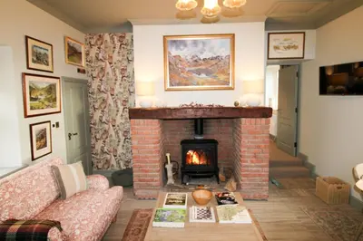 a living room with a fireplace and a couch at Drakes Rest, Kirklinton with hot tub, ideal romantic escape in Kirklinton