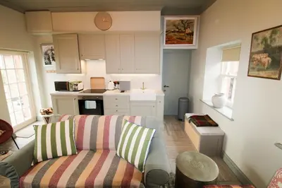 a living room with a couch and a kitchen at Drakes Rest, Kirklinton with hot tub, ideal romantic escape in Kirklinton