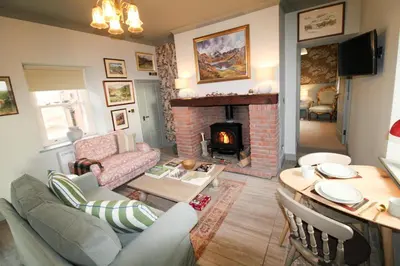 a living room with a couch and a fireplace at Drakes Rest, Kirklinton with hot tub, ideal romantic escape in Kirklinton