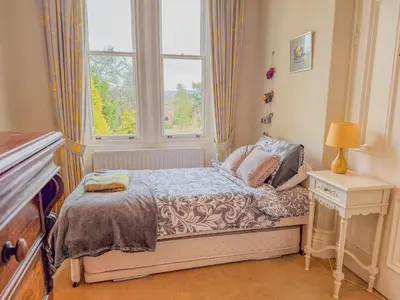 a small bedroom with a bed and a window at Eden Mount, Wetheral, characteful, spacious home overlooking village green, close to M6 in Wetheral