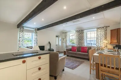 a kitchen and living room with a couch and a table at Ben Place Cottage - Grasmere in Grasmere