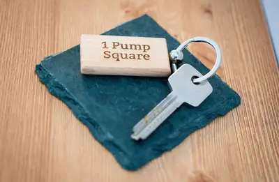 a keychain with a pump square on a table at Cosy Cottage on edge of Lake District in Little Broughton