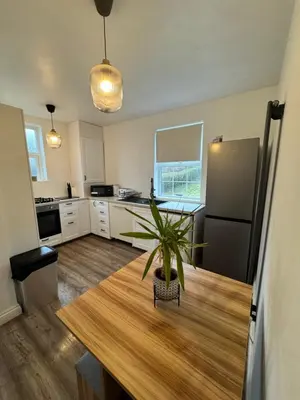 a kitchen with a table and a potted plant at Modern 3 Bedroom Home in Egremont, Western Lake District, Sleeps up to 6 in Egremont