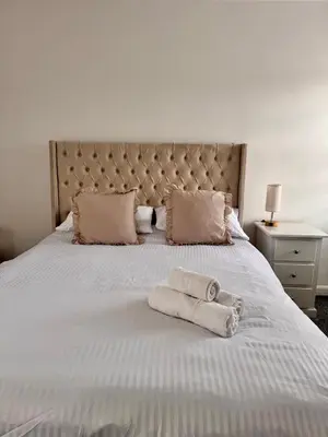 a bedroom with a bed with two towels on it at Modern 3 Bedroom Home in Egremont, Western Lake District, Sleeps up to 6 in Egremont
