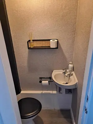 a small bathroom with a sink and a toilet at Cosy Cottage in Moffat, South Scotland in Moffat
