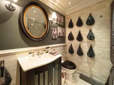 a bathroom with a sink and a mirror and a toilet at West London Boutique Apartment in Moffat