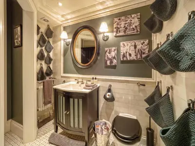 a bathroom with a sink and a toilet and a mirror at West London Boutique Apartment in Moffat