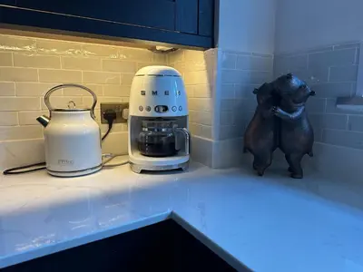 a kitchen counter with a blender and a toy bear on it at Riverview House in Minnigaff