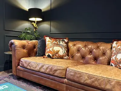 a brown leather couch sitting in a living room at Riverview House in Minnigaff