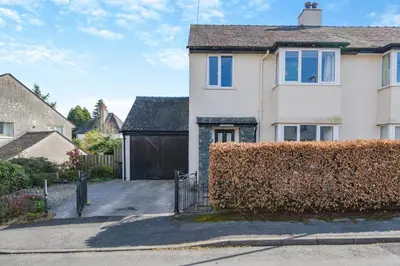 a house with a hedge in front of a driveway at 3 Bed in Portinscale oc-w31059 in Portinscale