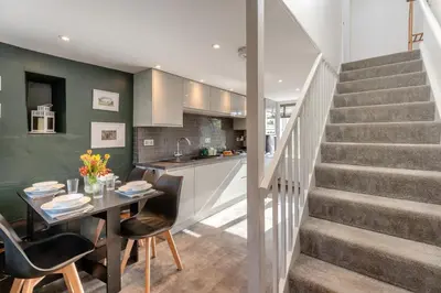 a kitchen and dining room with a table and stairs at 2 Bed in Dean oc-h32066 in Dean