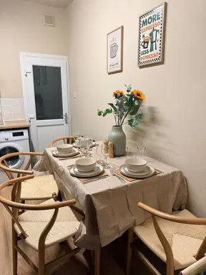 a dining room table with chairs and a vase with flowers at Contractor 4BD Carlisle Long Stay w Wi-Fi, Washer, Smart TVs & Parking in Carlisle