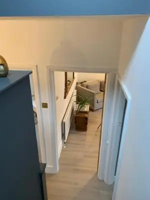 a hallway with a stairway leading to a room at Crouch End in Moffat