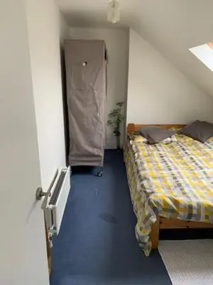 a room with two beds in a room with a door at Crouch End in Moffat