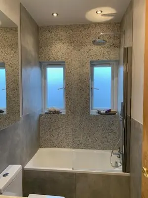 a bathroom with a bath tub and two windows at Crouch End in Moffat